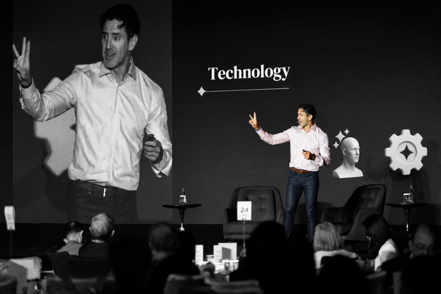 Oseas Ramírez Assad on stage with the word Technology projected behind him.
